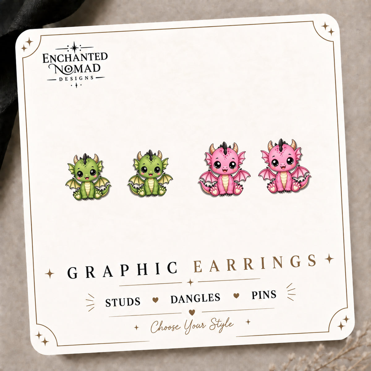 Baby Dragon Graphic Stud Earrings on the tilted Enchanted Nomad Designs card