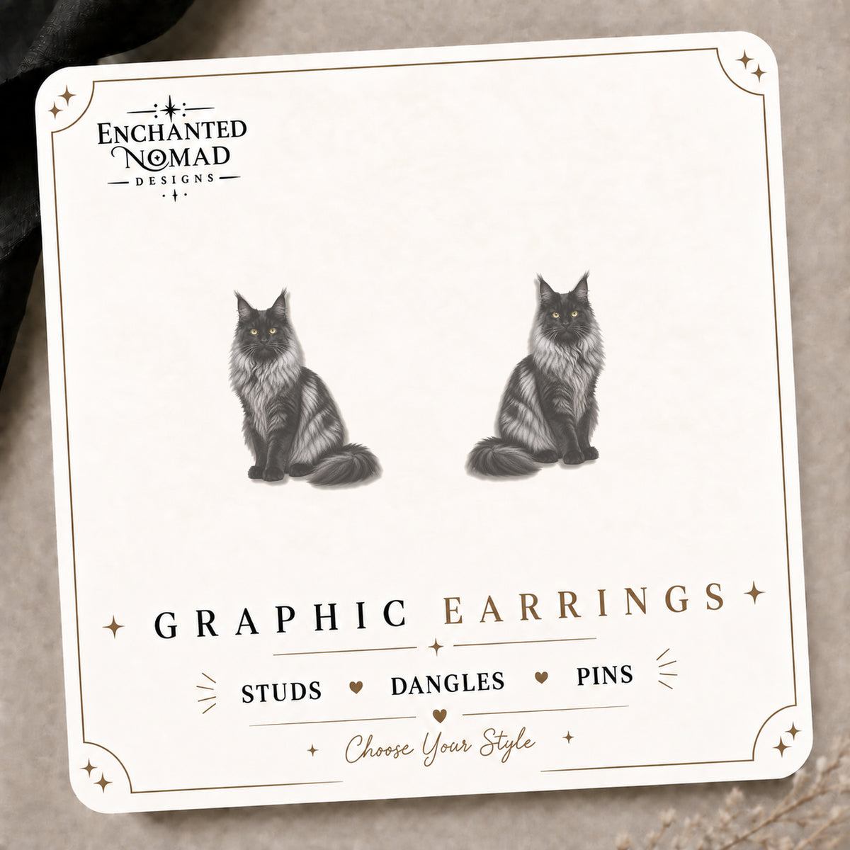 Black Smoke Maine Coon Cat Stud Earrings on the tilted Enchanted Nomad Designs card