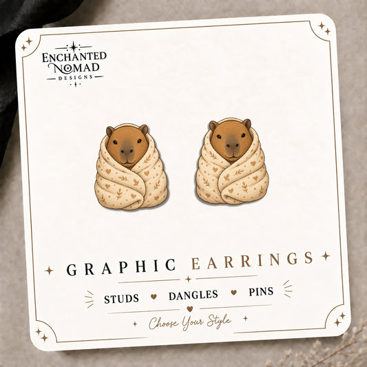 Capybara Blanket Stud Earrings on the tilted Enchanted Nomad Designs card