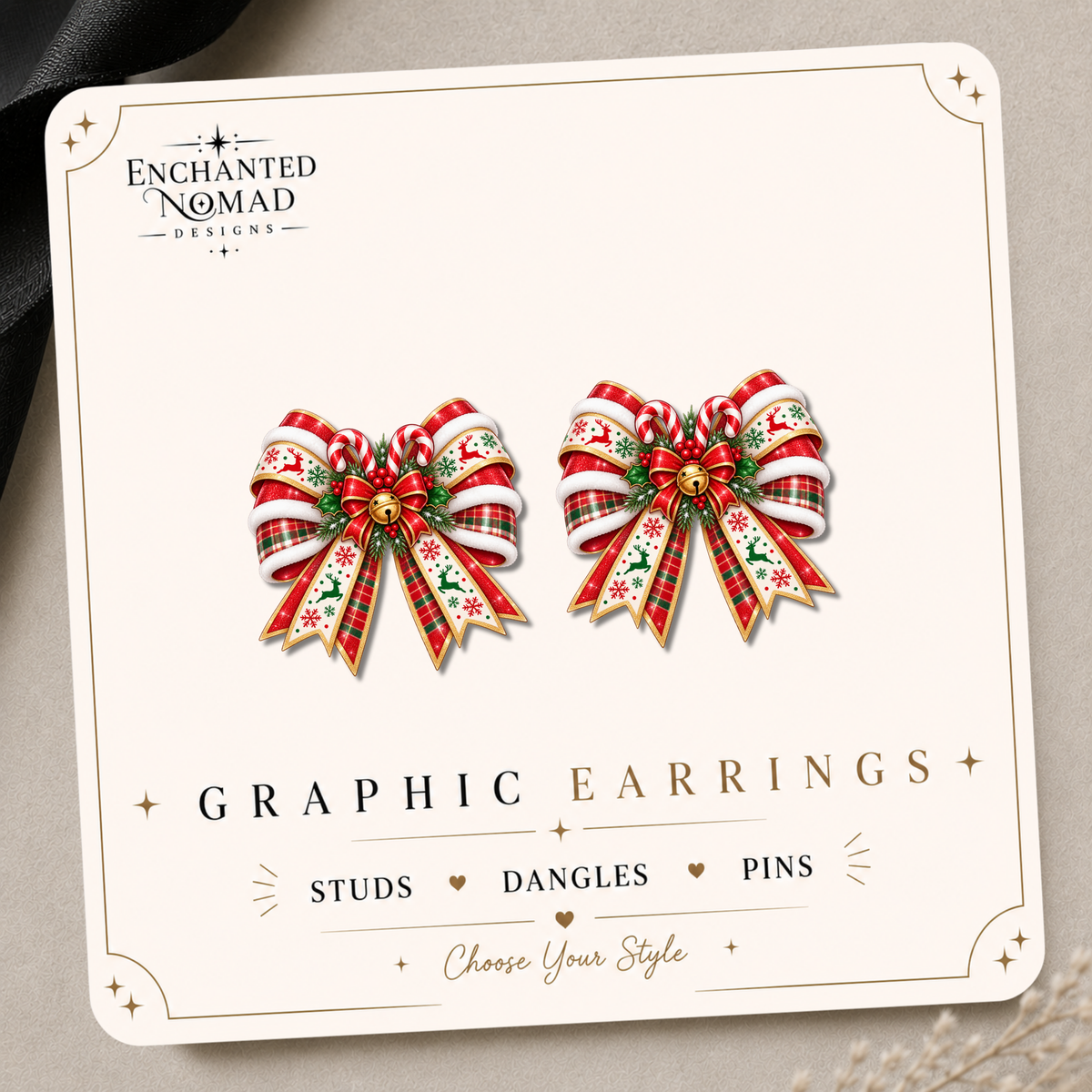 Red and green Christmas bow graphic earrings with candy canes, holly, reindeer ribbon and a gold bell on an Enchanted Nomad Designs display card.