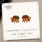 Christmas Capybara Stud Earrings on the tilted Enchanted Nomad Designs card