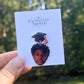 Personalized graduation lapel pin with graduate portrait on a display card.