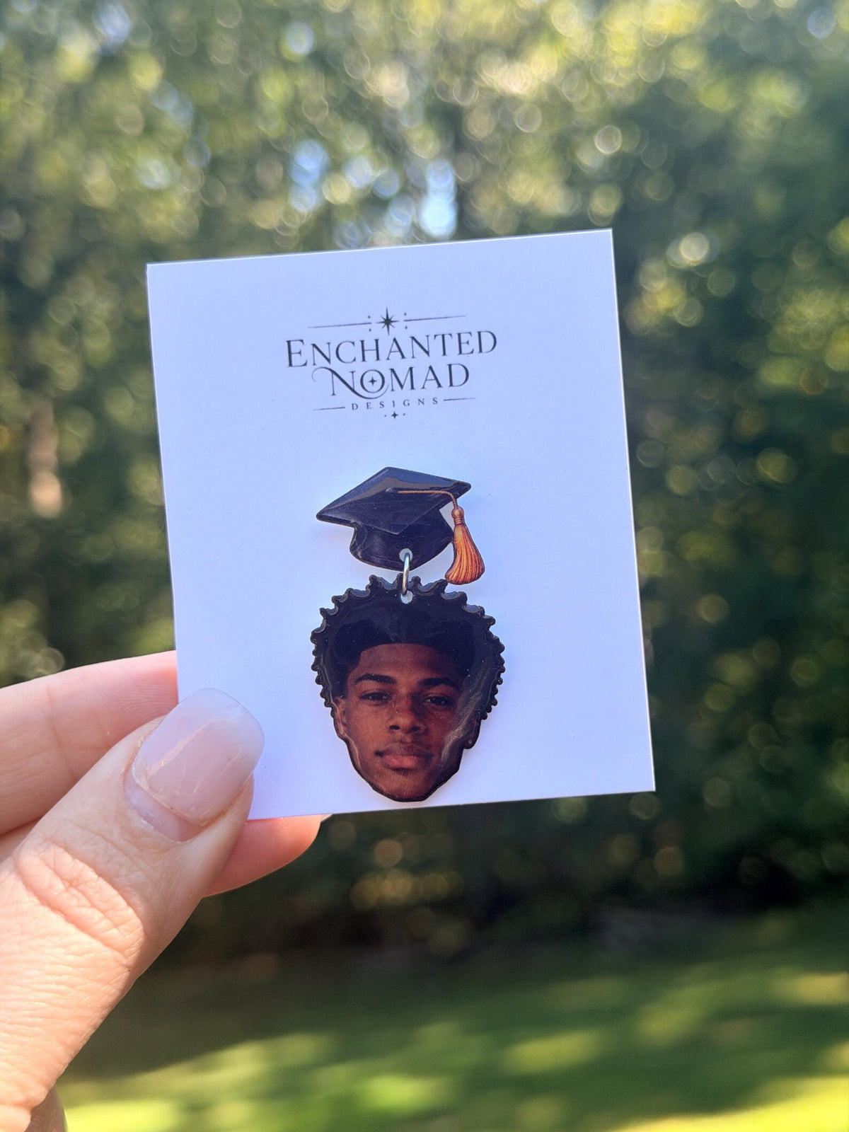 Personalized graduation lapel pin with graduate portrait on a display card.