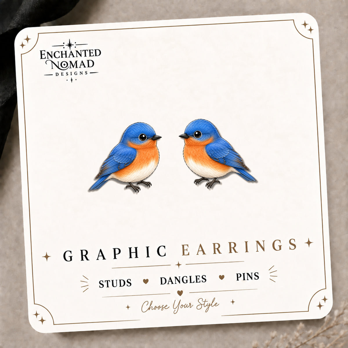 Eastern Bluebird Stud Earrings on the tilted Enchanted Nomad Designs card