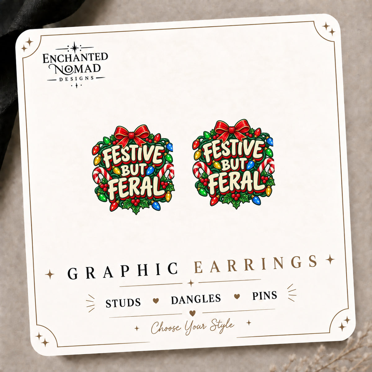 Festive But Feral Christmas Stud Earrings on the tilted Enchanted Nomad Designs card