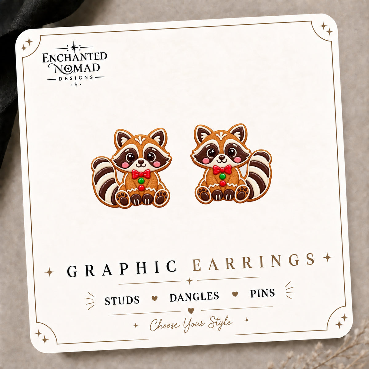 Gingerbread Raccoon Stud Earrings on the tilted Enchanted Nomad Designs card
