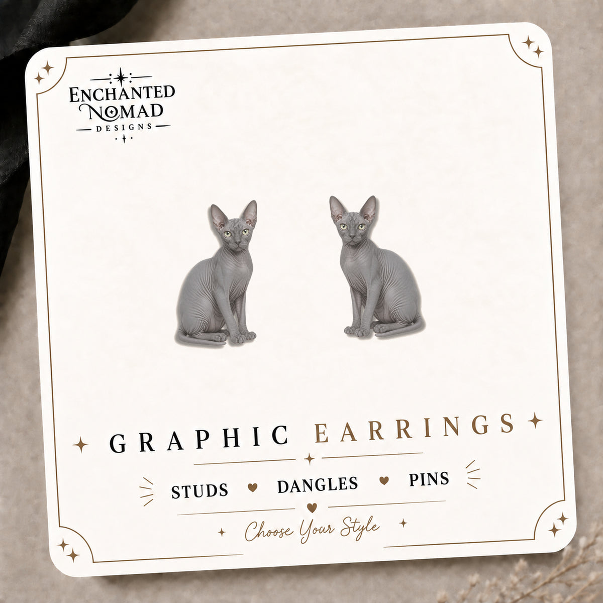 Gray Sphynx Cat Stud Earrings on the tilted Enchanted Nomad Designs card