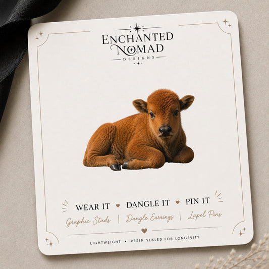 Baby Bison Earrings & Pins on a branded display card