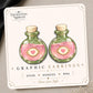 Pink Love Potion Bottle Earrings & Pins on original display card