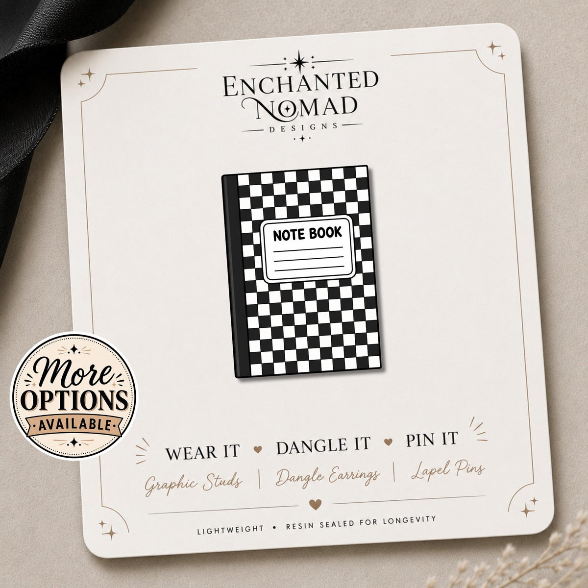 Checkerboard Notebook Earrings & Pins on a branded display card