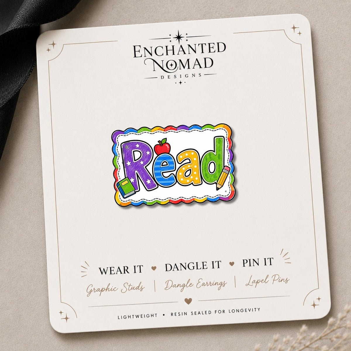 Read Earrings & Pins on a branded display card