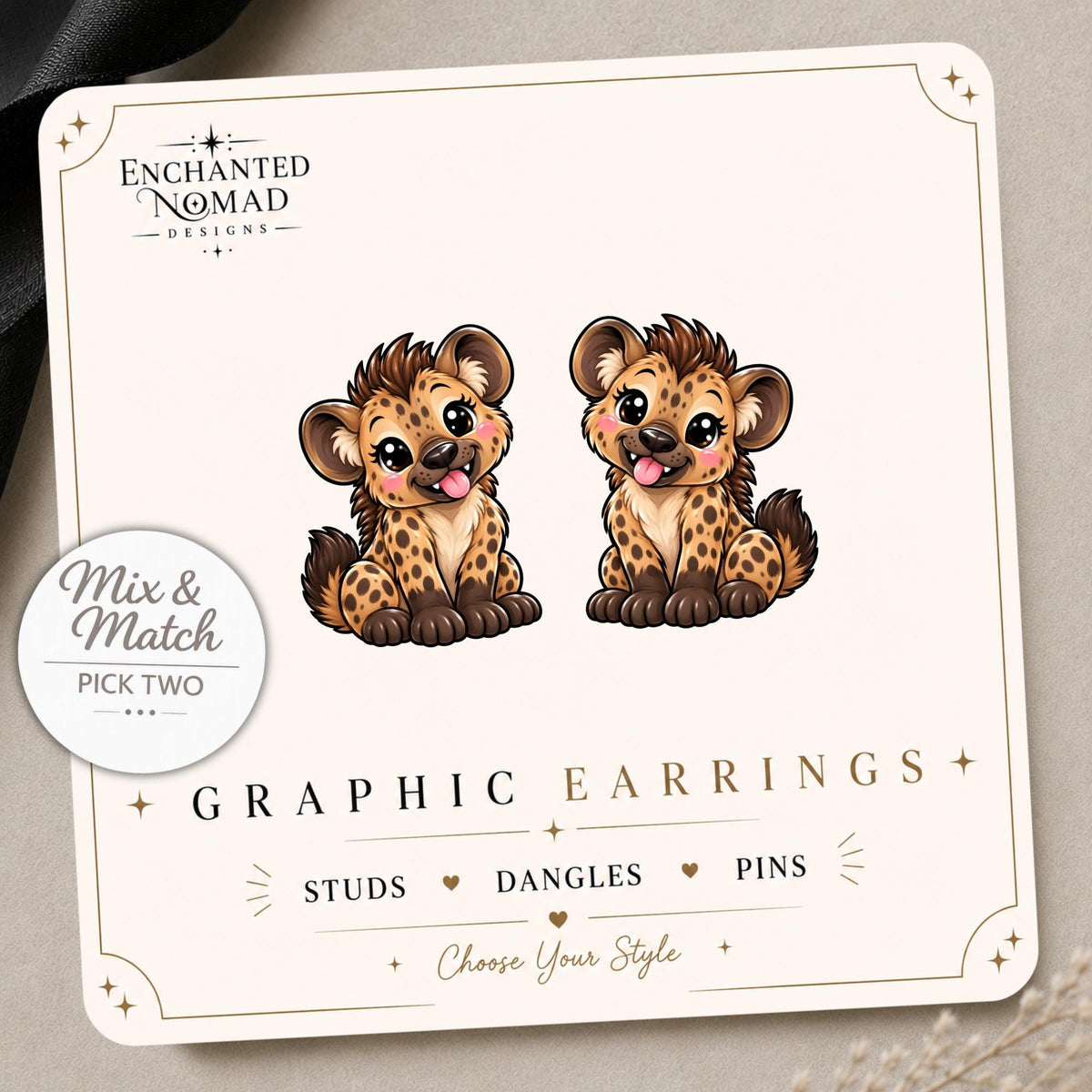 Spotted Hyena graphic earrings and pins on a display card