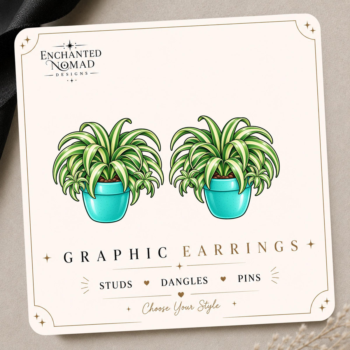 Spider Plant graphic earrings and pins on a display card