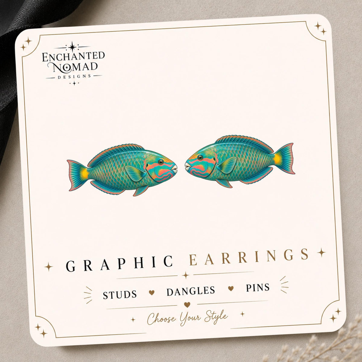 Parrotfish graphic earrings and pins on a display card