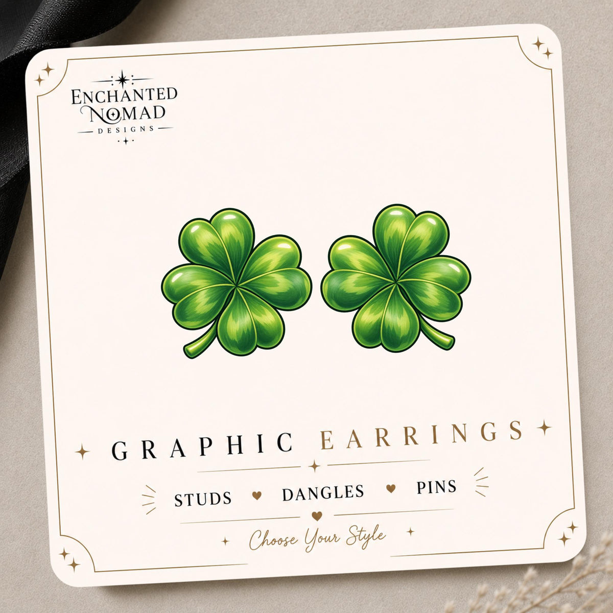 Four Leaf Clover graphic earrings and pins on a display card