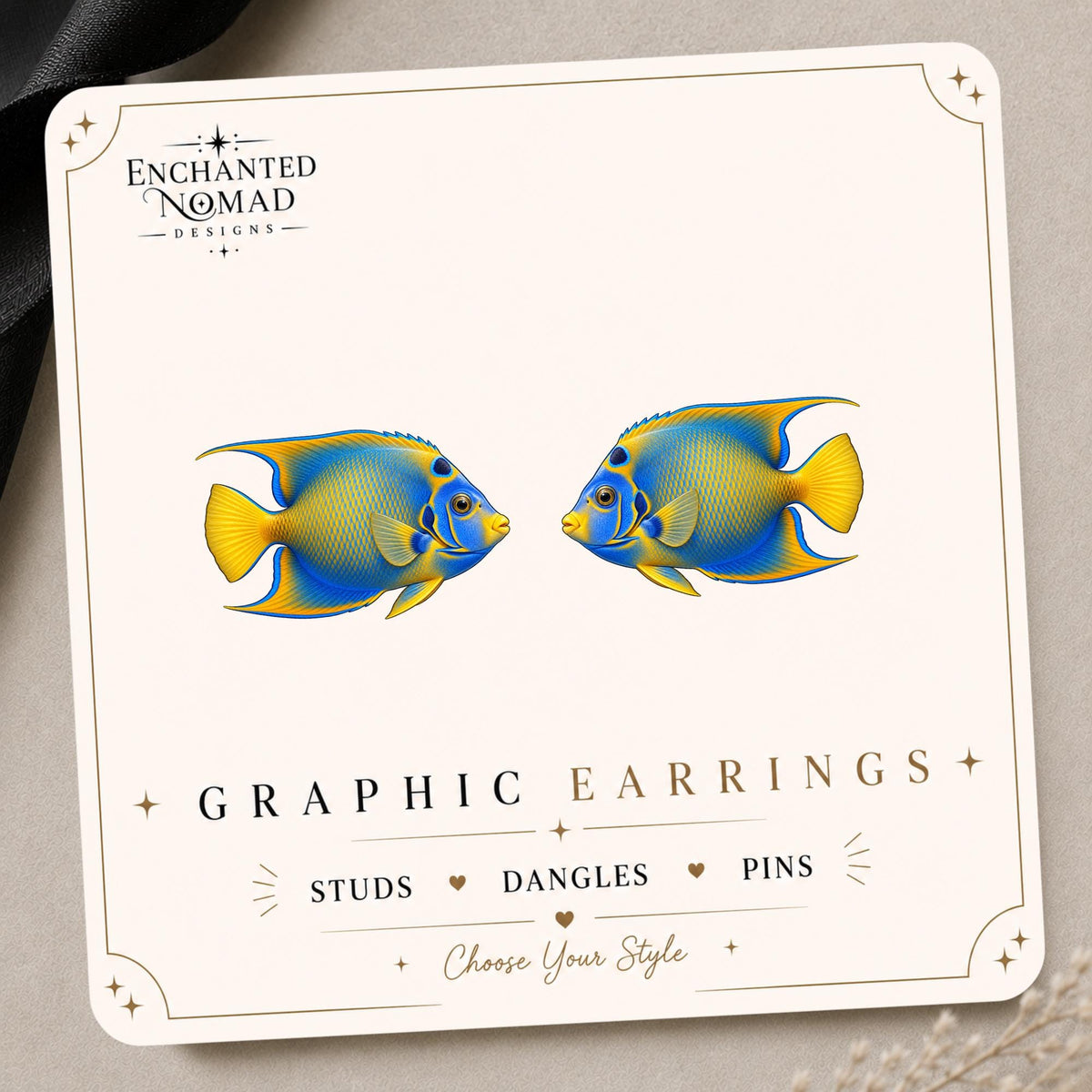 Blue Angelfish graphic earrings and pins on a display card