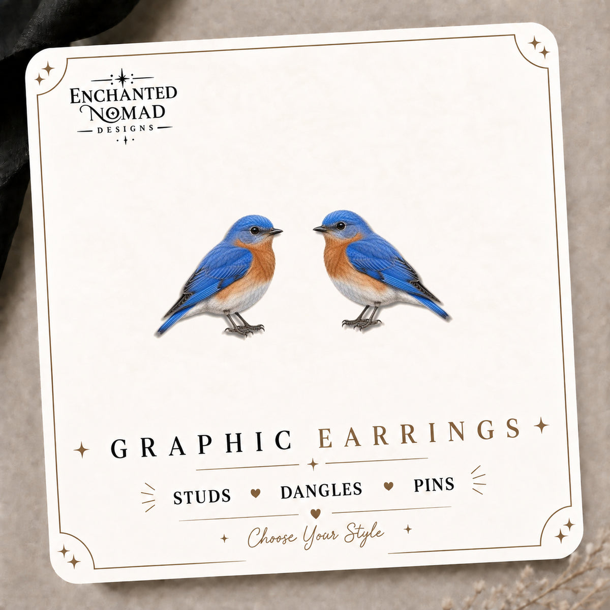 National Park Inspired Bluebird Stud Earrings on the tilted Enchanted Nomad Designs card