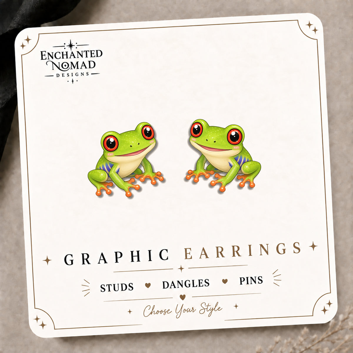 Red-Eyed Coquí Frog Stud Earrings on the tilted Enchanted Nomad Designs card