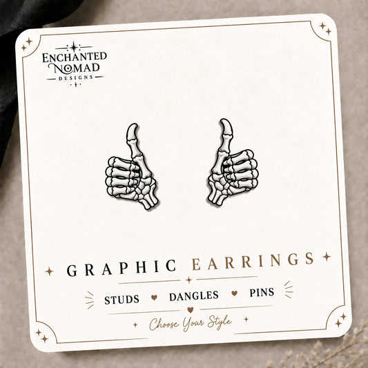 Skeleton Thumbs Up Stud Earrings on the tilted Enchanted Nomad Designs card