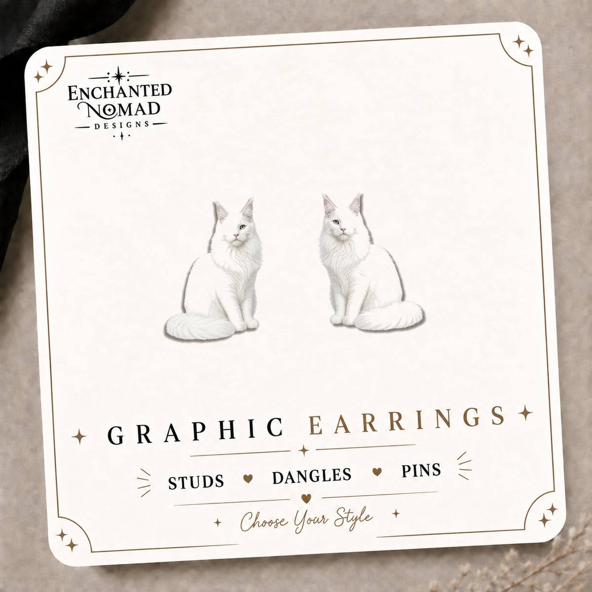 White Maine Coon Cat Stud Earrings on the tilted Enchanted Nomad Designs card